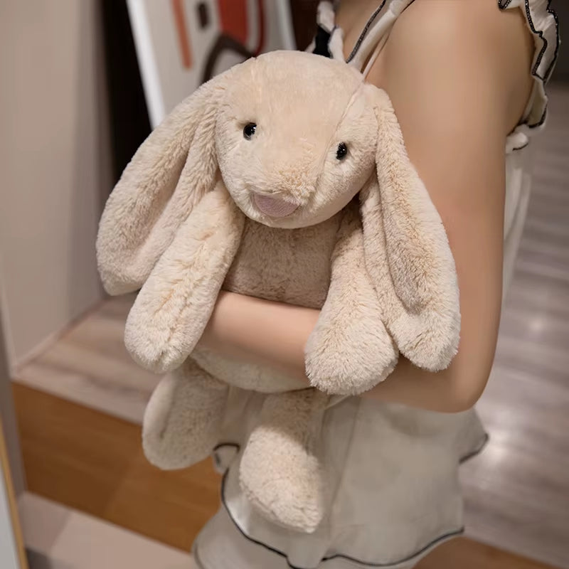 Peluche lapin kawaii longues oreilles doudou ultra doux tenu dans les mains